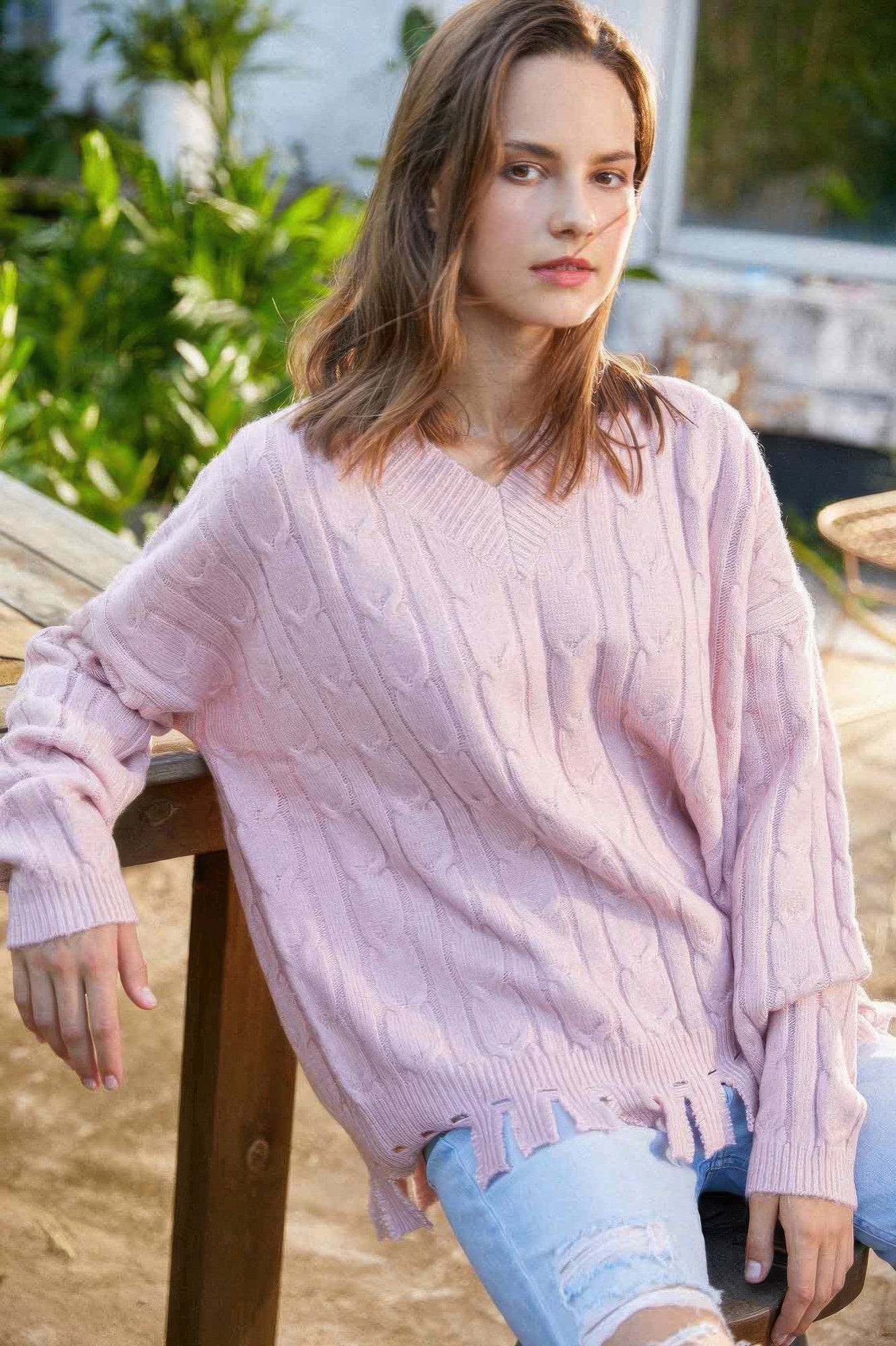 Solid knit sweater in light pink with cable texture, crew neck, long sleeves, ribbed cuffs