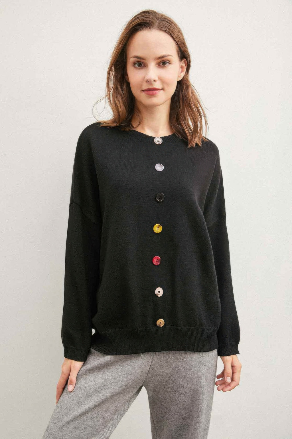 Black sweater with multicolor button front placket and long sleeves