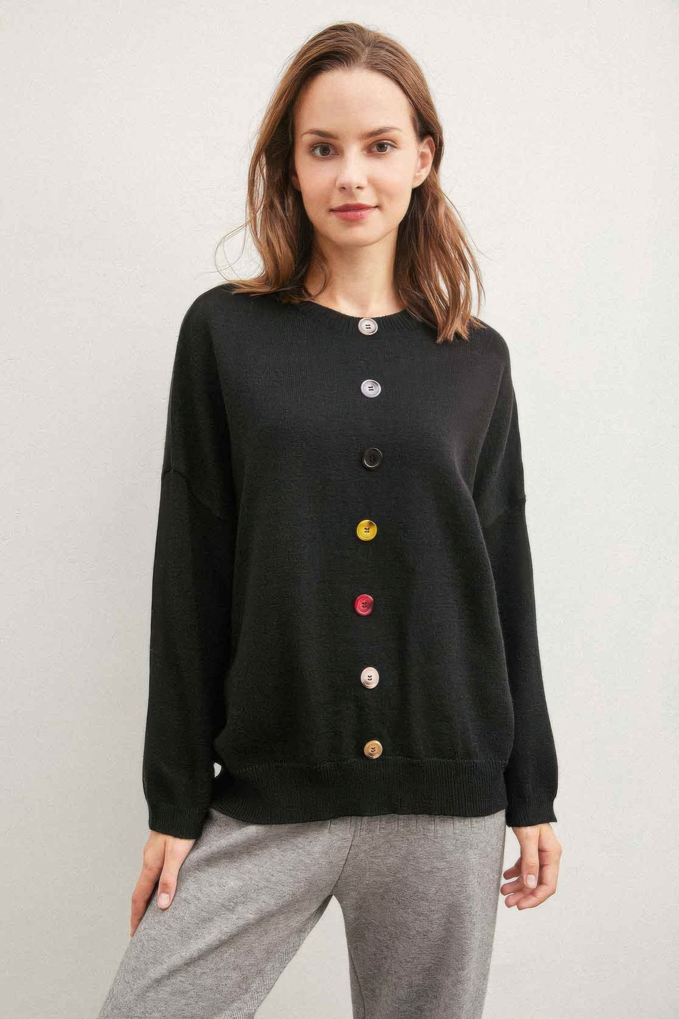 Black sweater with multicolor button front placket and long sleeves