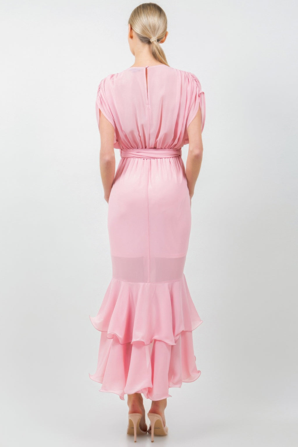 Back view of solid pink midi dress with tie waist and ruffled hem