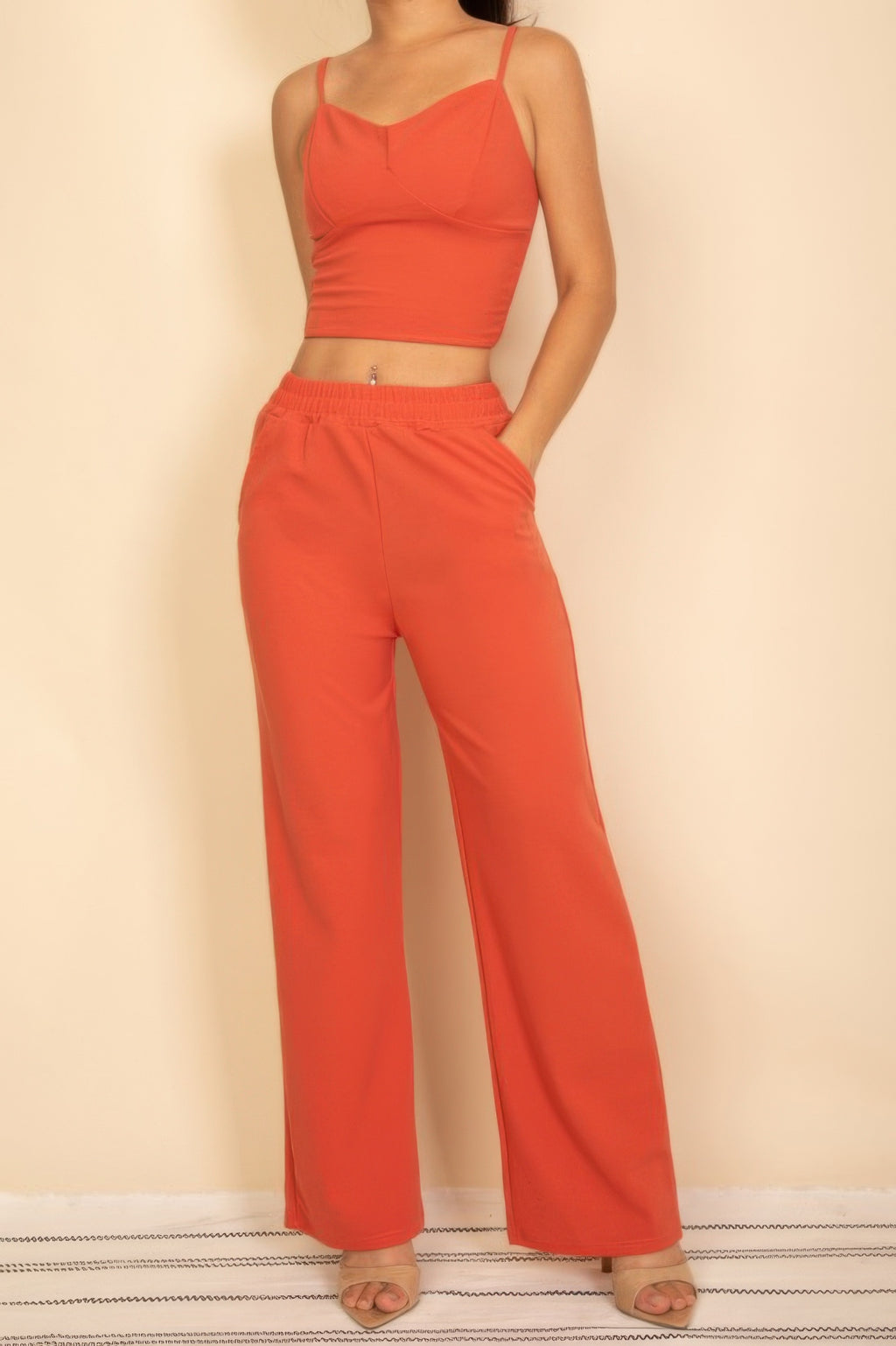 Rust red crop bralette with matching high-waist wide-leg pants