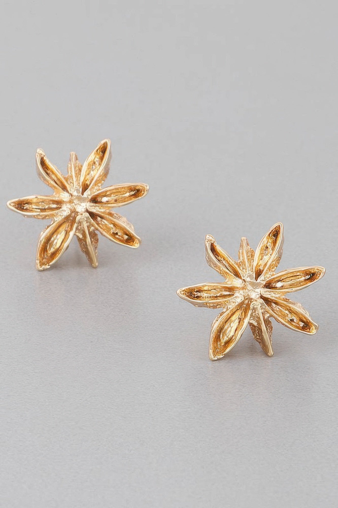 Gold Spice Flower stud earrings with five petal star design