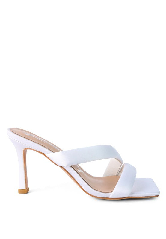 White cross-strap slide heels with open toe and slim stiletto heel