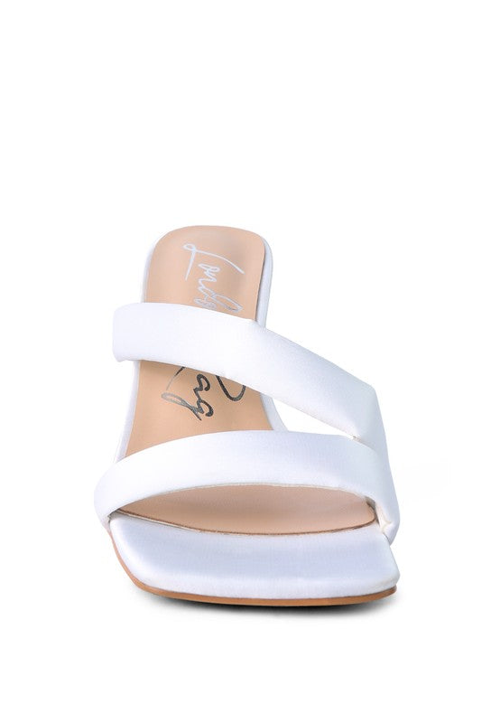 White cross-strap slide heels with cushioned footbed and high heel