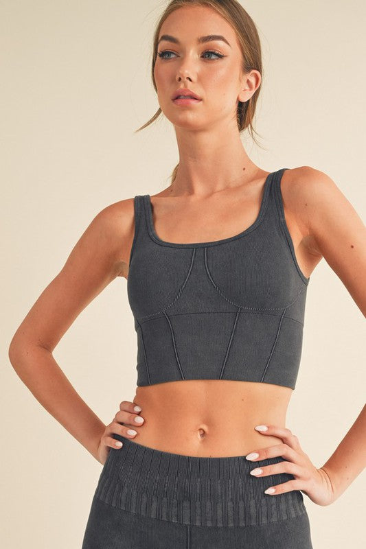 Ribbed sports bra with wide straps and seamed cups, dark grey color.