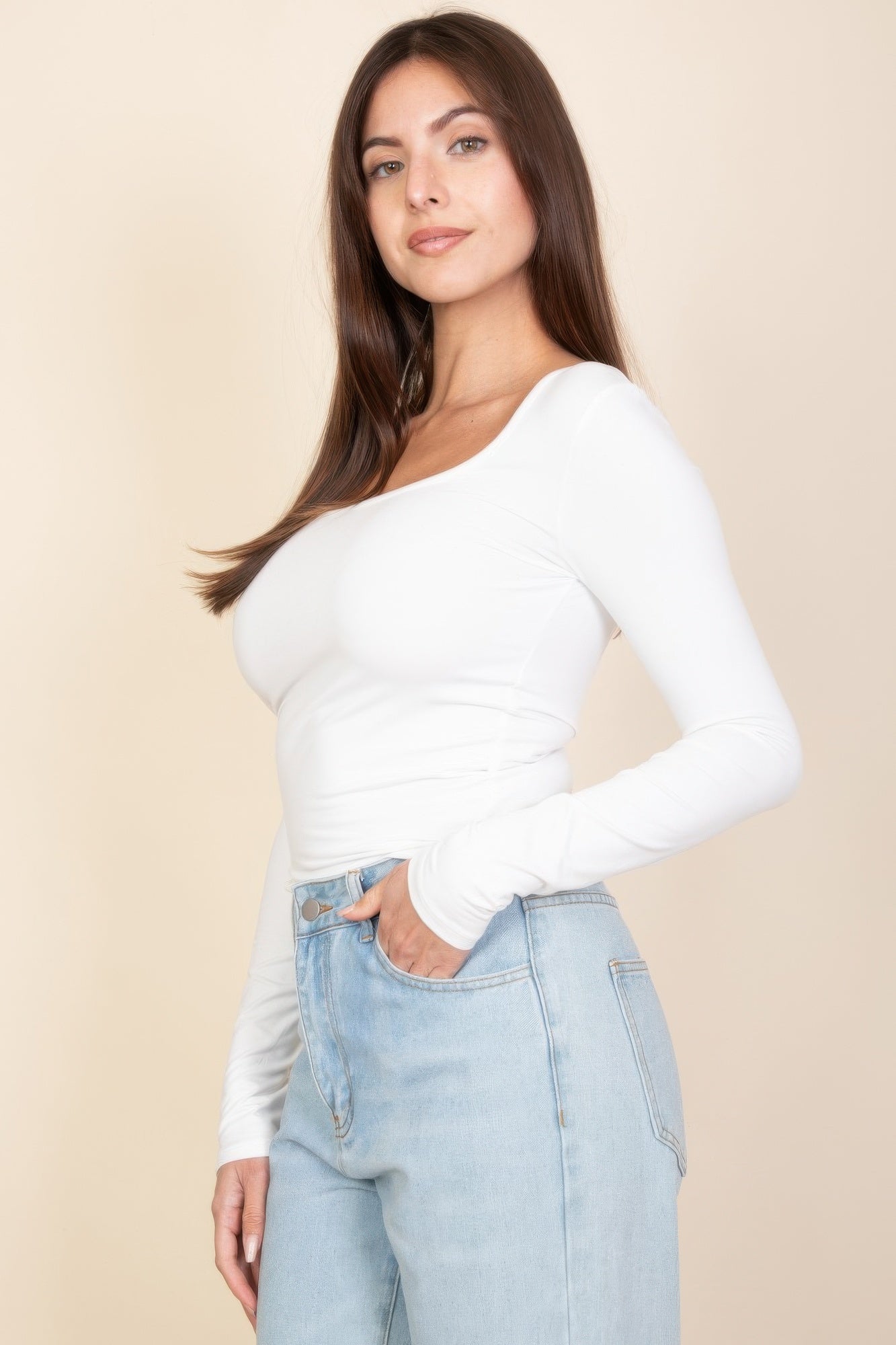 White square-neck long-sleeve top with side drape and ruched waist detail