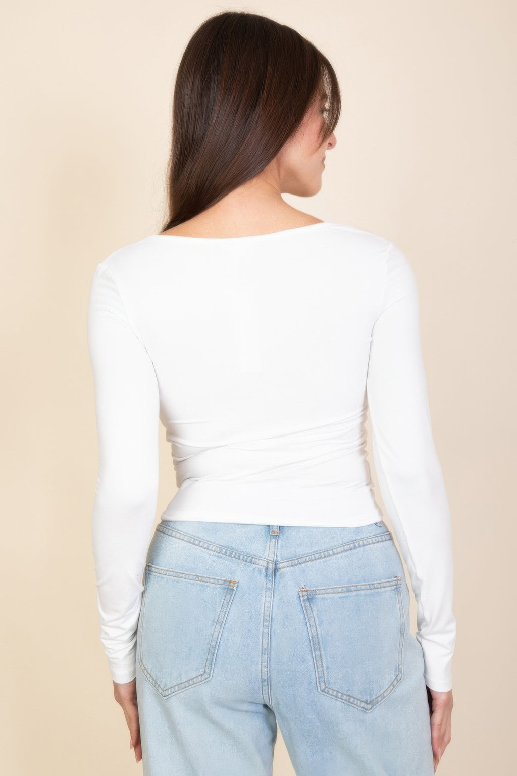 Back view of white square-neck long-sleeve top with ruched waist seam
