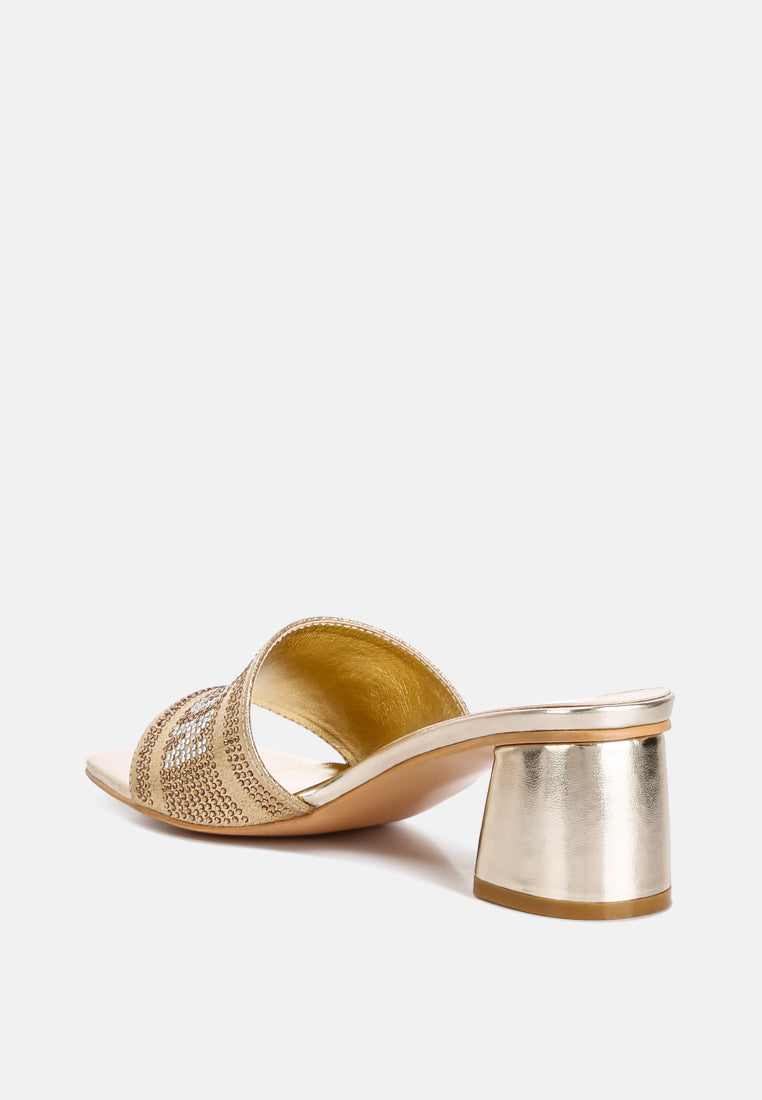 Gold slide sandals showing metallic block heel and open square toe