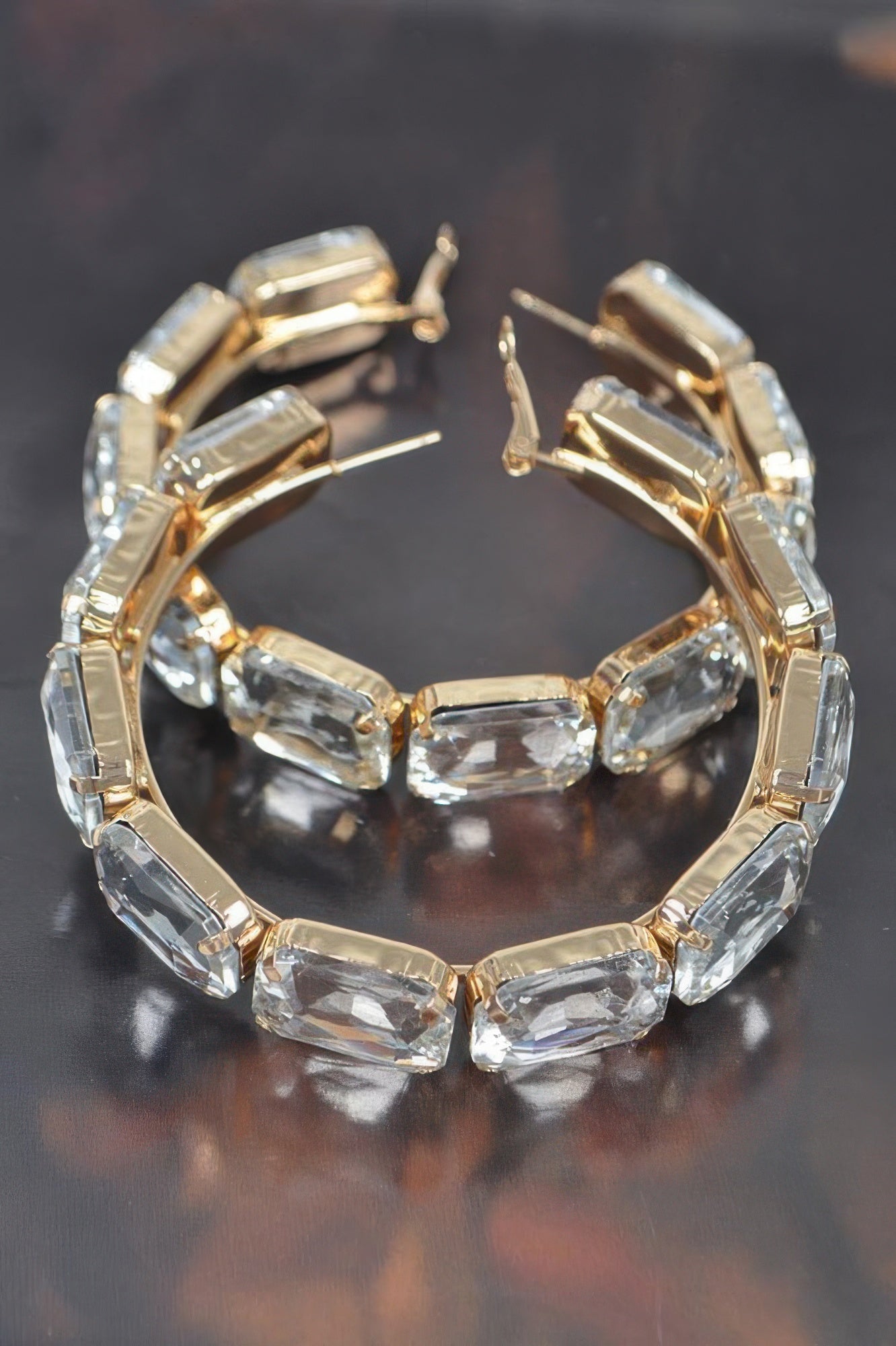 Clear blue stone hoop earrings with gold-tone prong settings