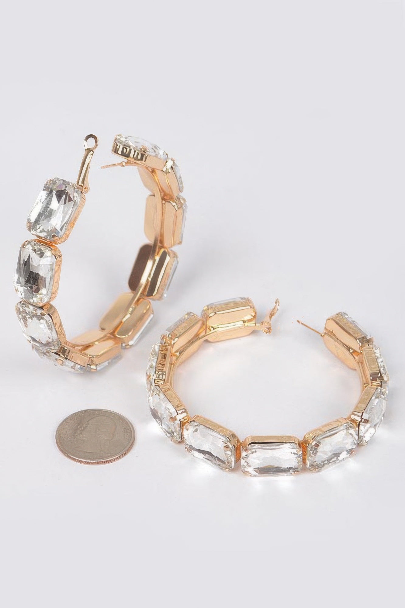 Clear stone hoop earrings with gold-tone hinge and earring back