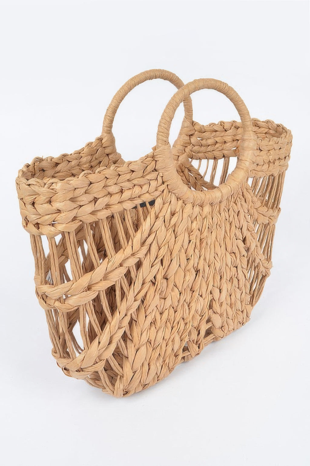 Khaki straw beach bag, side view with woven lattice panels and rope handles