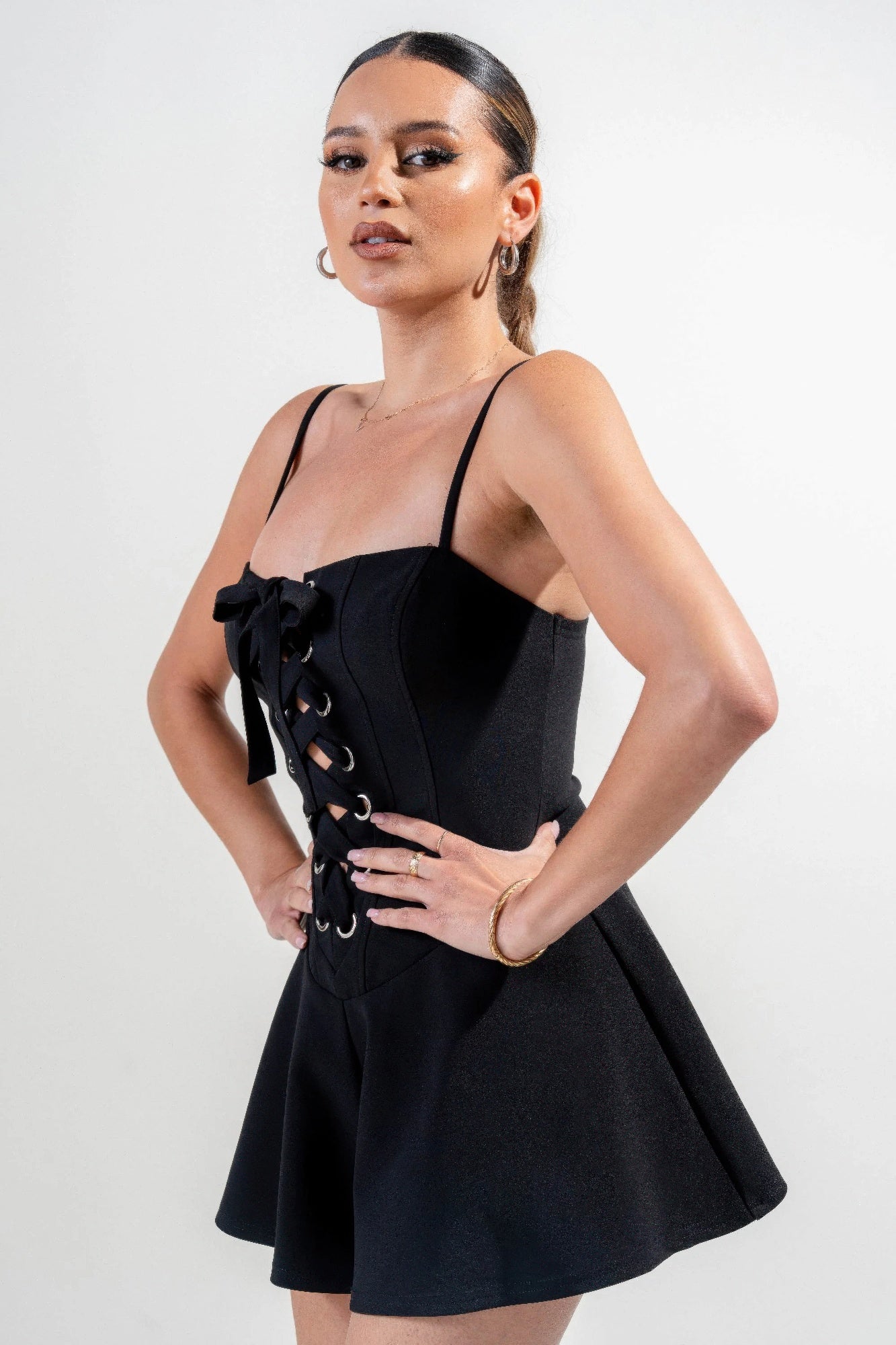 Stretch woven jumpsuit, black; corset-style lace-up front and wide flared skirt