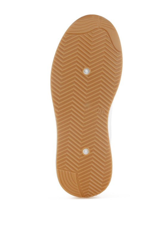 Tan outsole with zigzag tread pattern and grip dots