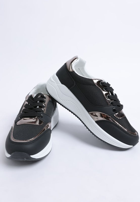 Black chunky lace-up sneakers with metallic eyelets and thick white midsole