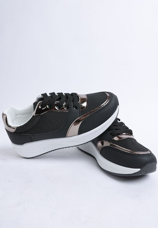 Black chunky lace-up sneakers with white sole and metallic accent stripes