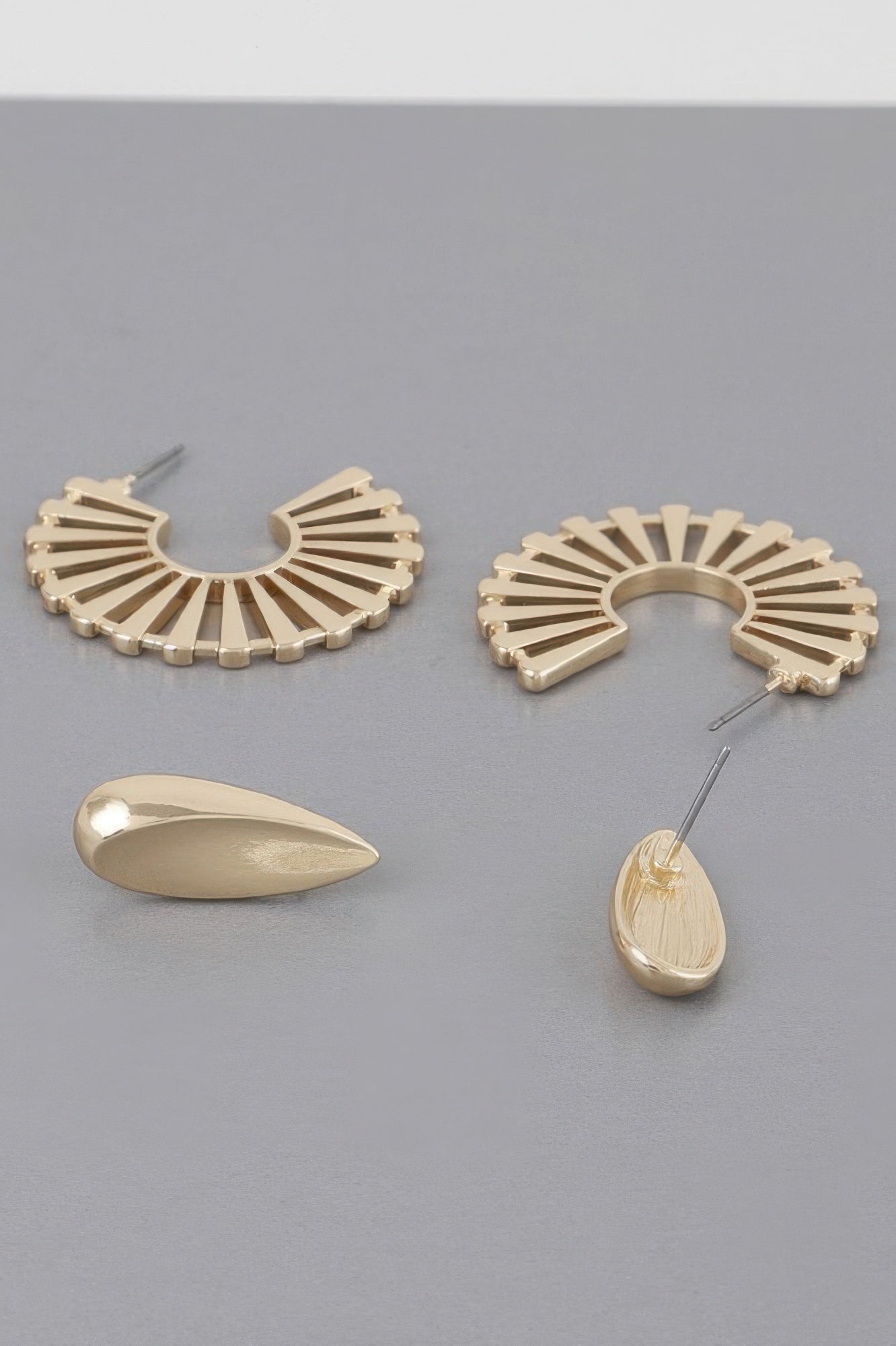 Sunray flat hoop earrings in gold-tone; fan-shaped hoops and teardrop drop pieces.