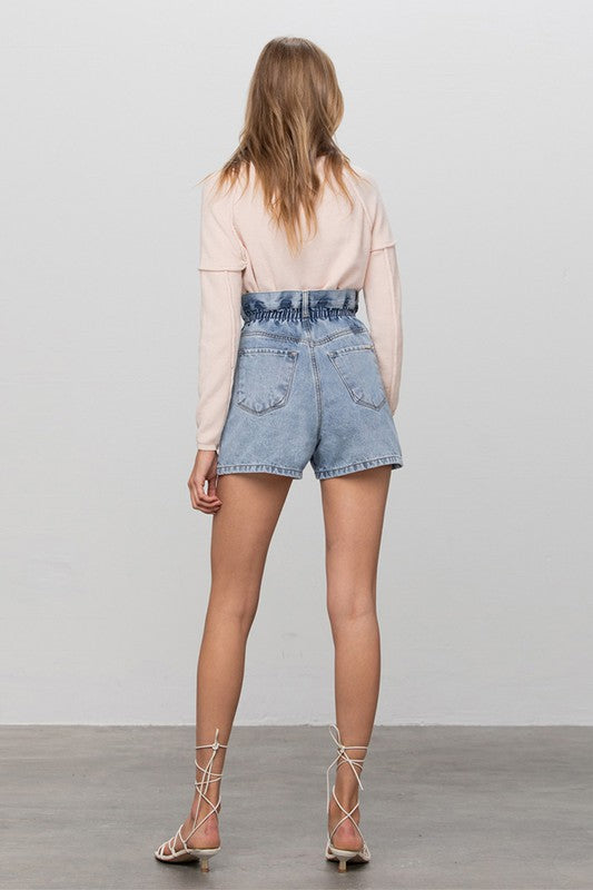Light-wash high-rise denim shorts, back view with patch pockets and elastic waistband