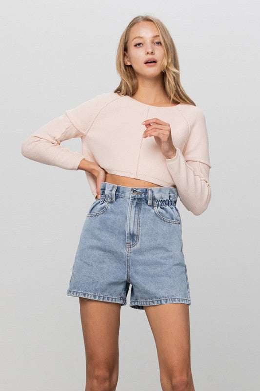 Light-wash high-rise denim shorts with elastic waistband and front button placket