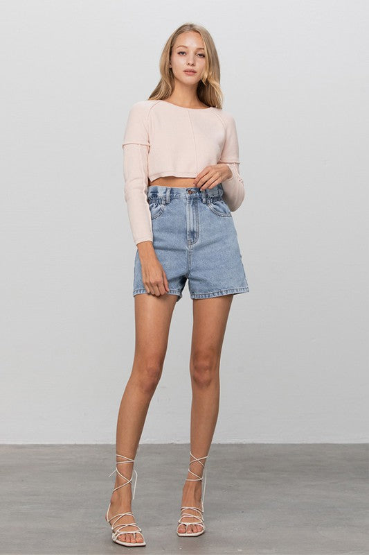 Light-wash high-rise denim shorts with elastic waistband, front pockets, and rolled hem