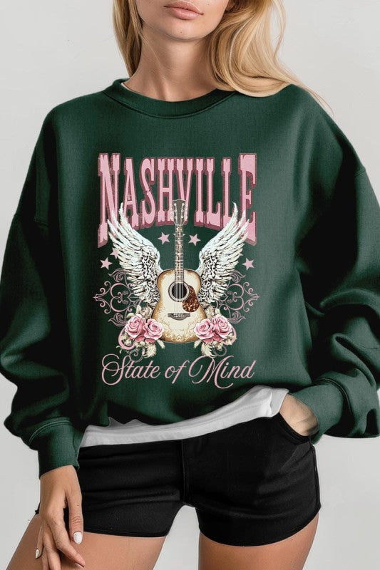 Forest green sweatshirt with Nashville guitar-and-wings graphic and pink rose accents