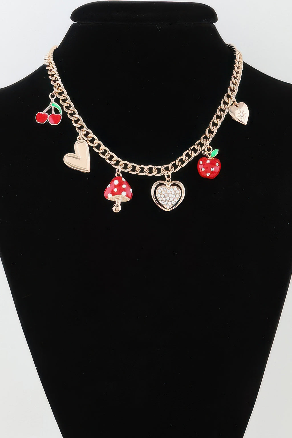 Gold chain necklace with red mushroom and heart charms, plus apple and bow
