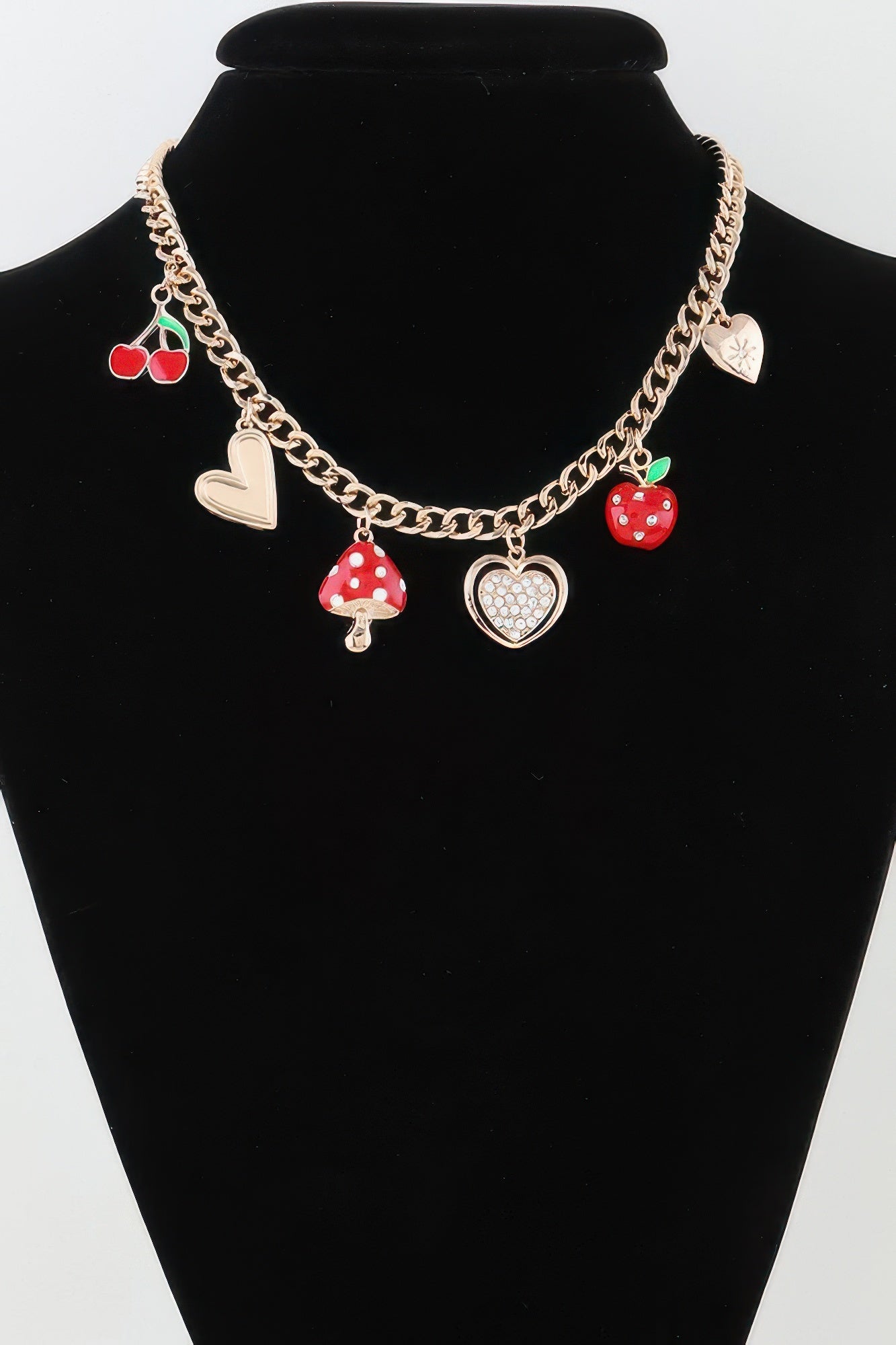 Gold chain necklace with red mushroom and heart charms, plus apple and bow