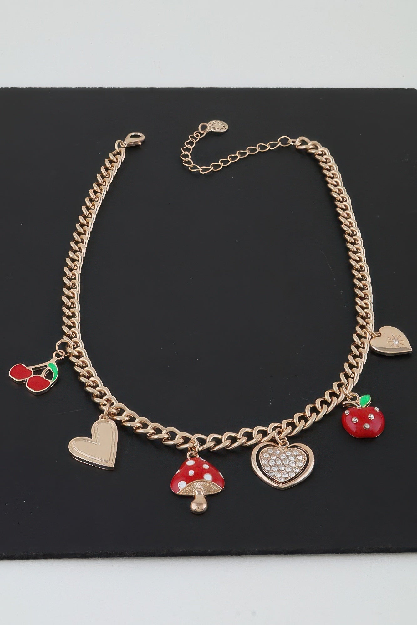 Gold charm chain necklace, red mushroom and apple charms with heart pendants