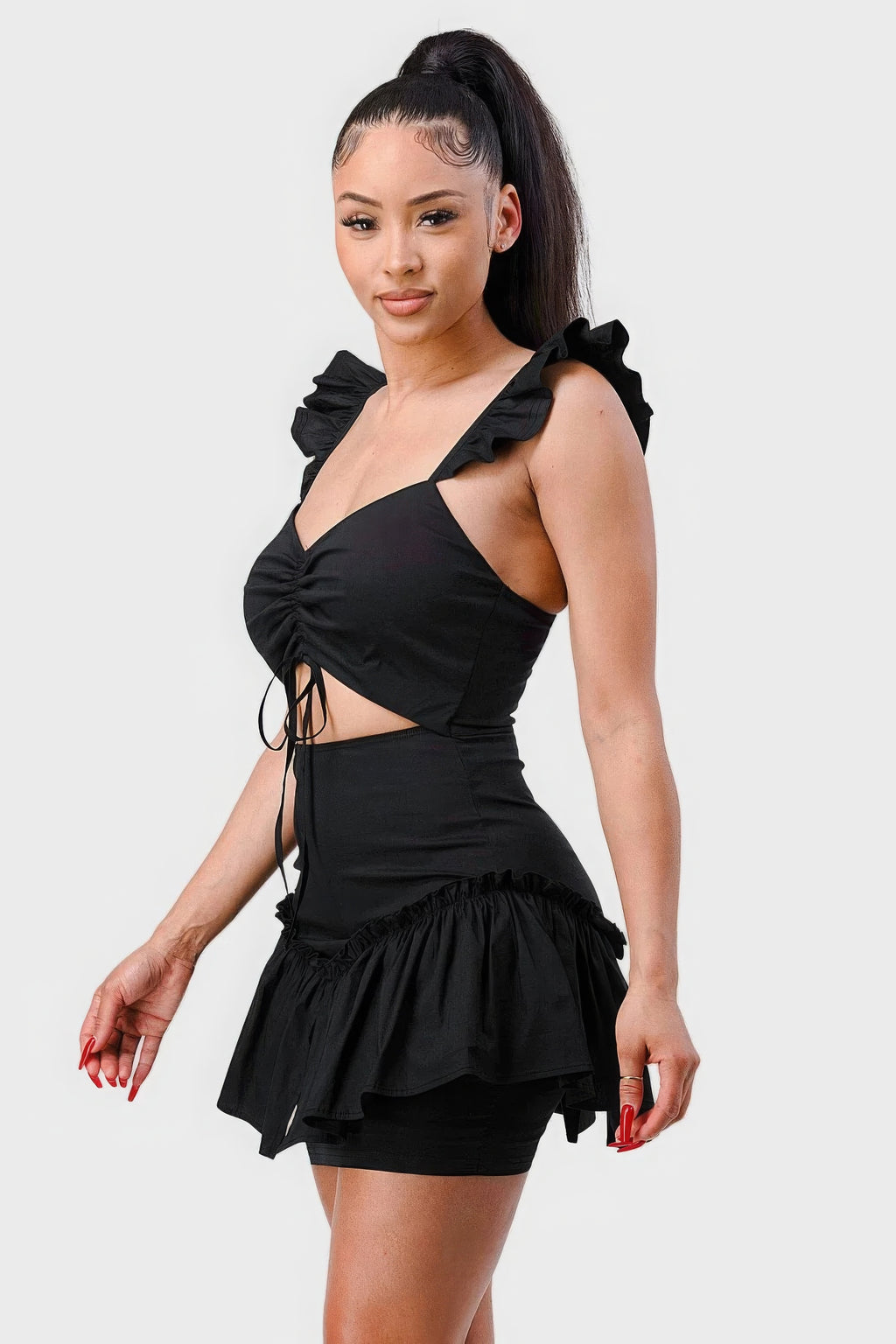 Black mini dress side view with sweetheart bust, ruched waist, and ruffled flutter sleeves