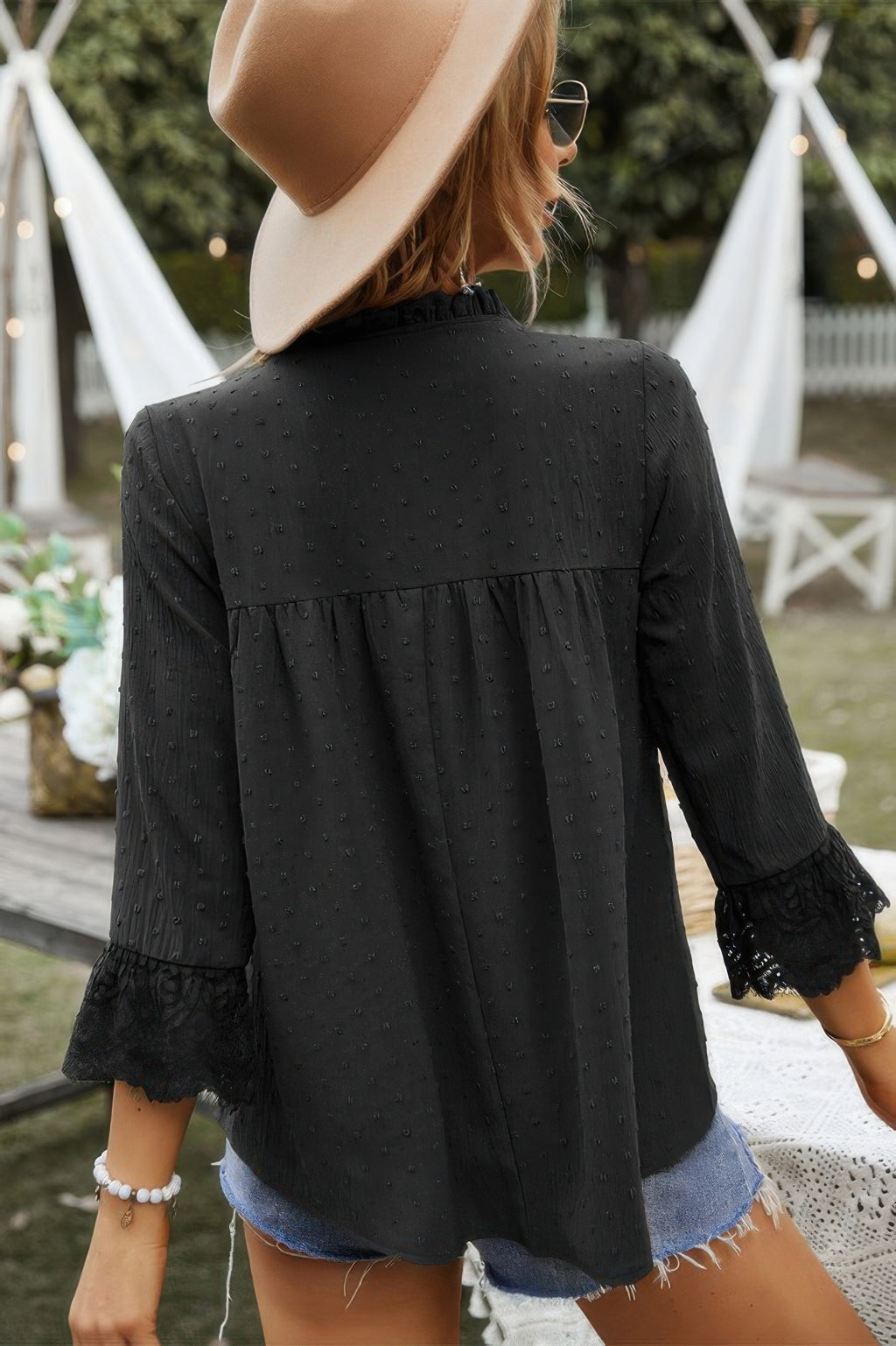 Back view of black Swiss-dot lace sleeve V-neck blouse