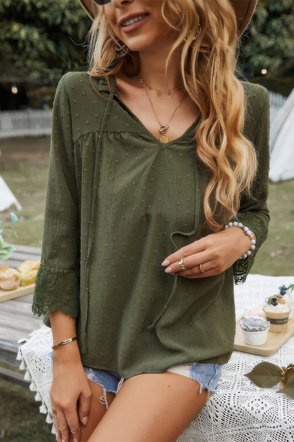 Olive green blouse with V-neck and lace-trimmed sleeve openings