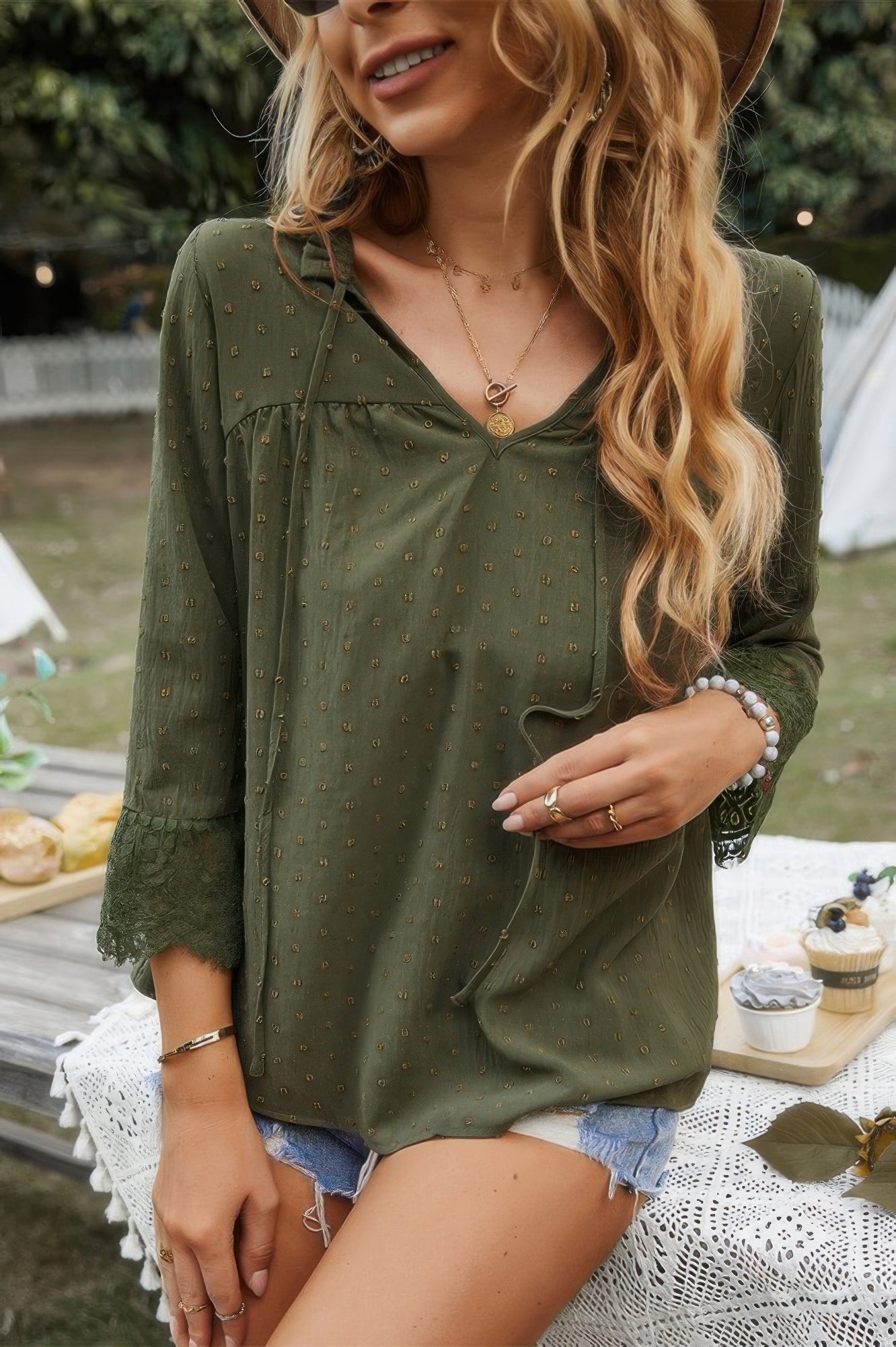 Olive green blouse with V-neck and lace-trimmed sleeve openings