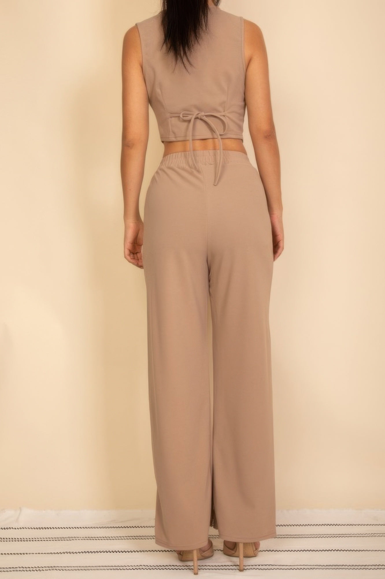 Taupe button-up vest with adjustable back tie and matching wide-leg pants