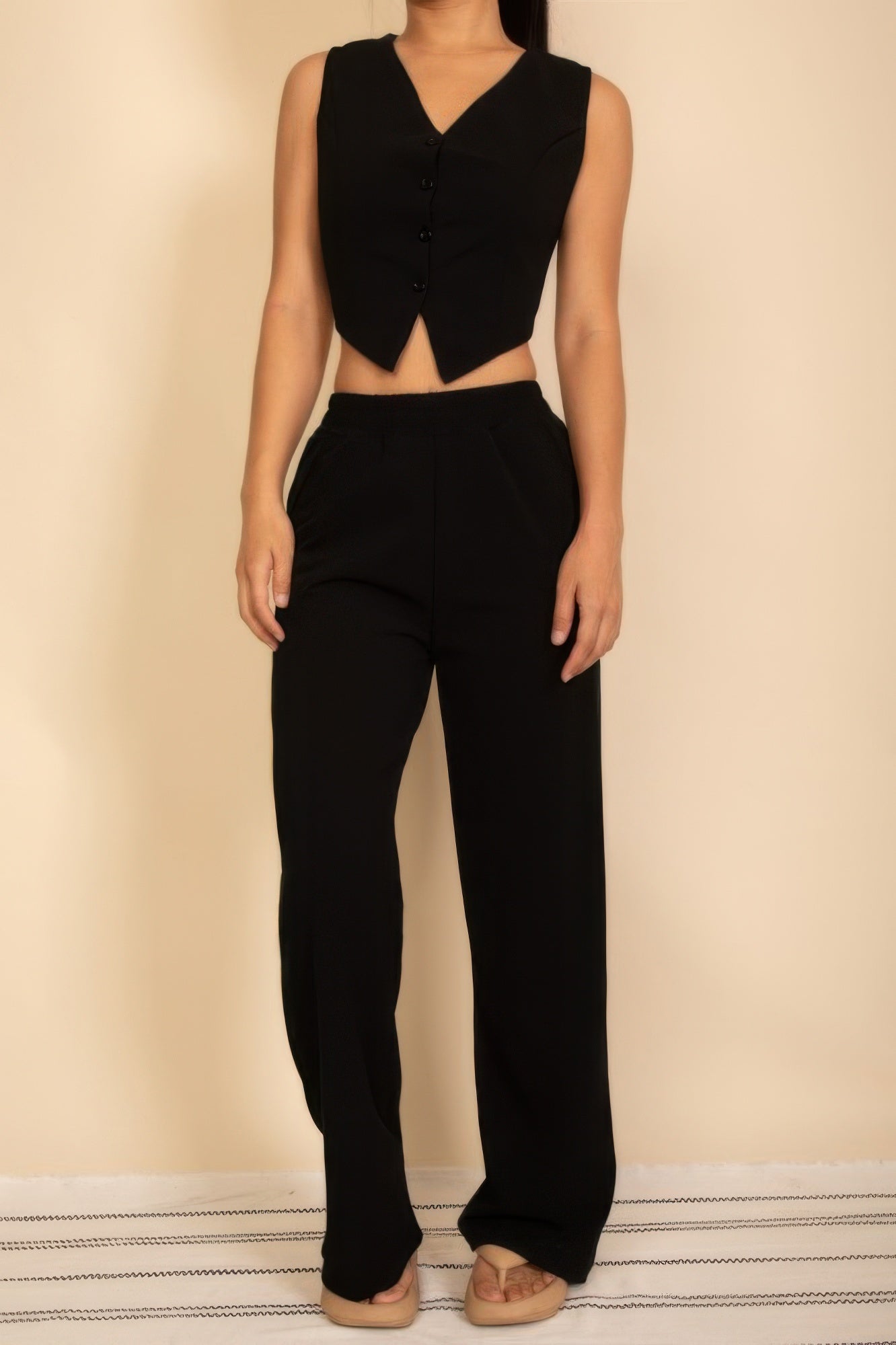 Black sleeveless button vest and wide-leg pants set with matching fitted waist
