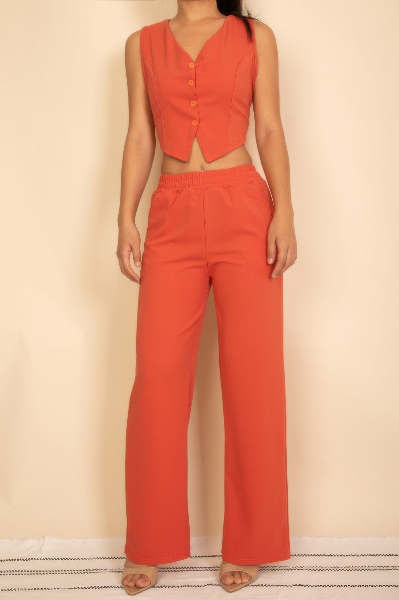 Rust-red tailored button vest with adjustable back tie and wide-leg pants set