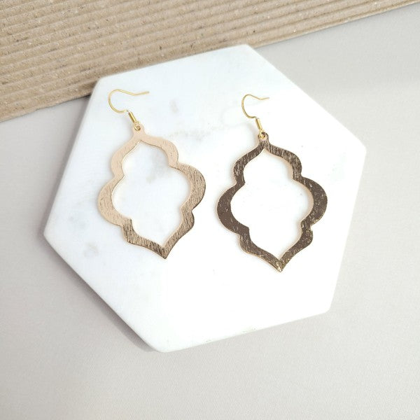 Gold openwork quatrefoil earrings with fishhook ear wires, hanging silhouette