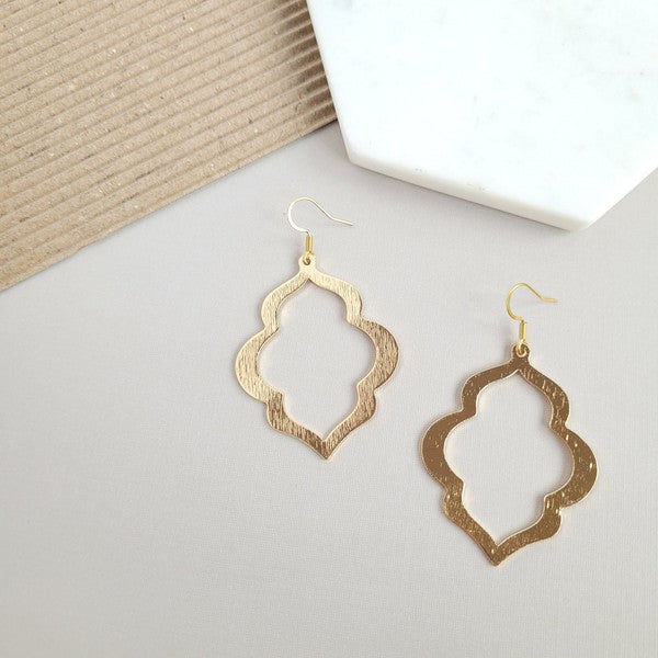 Gold quatrefoil drop earrings with open center and fishhook ear wires, pair view