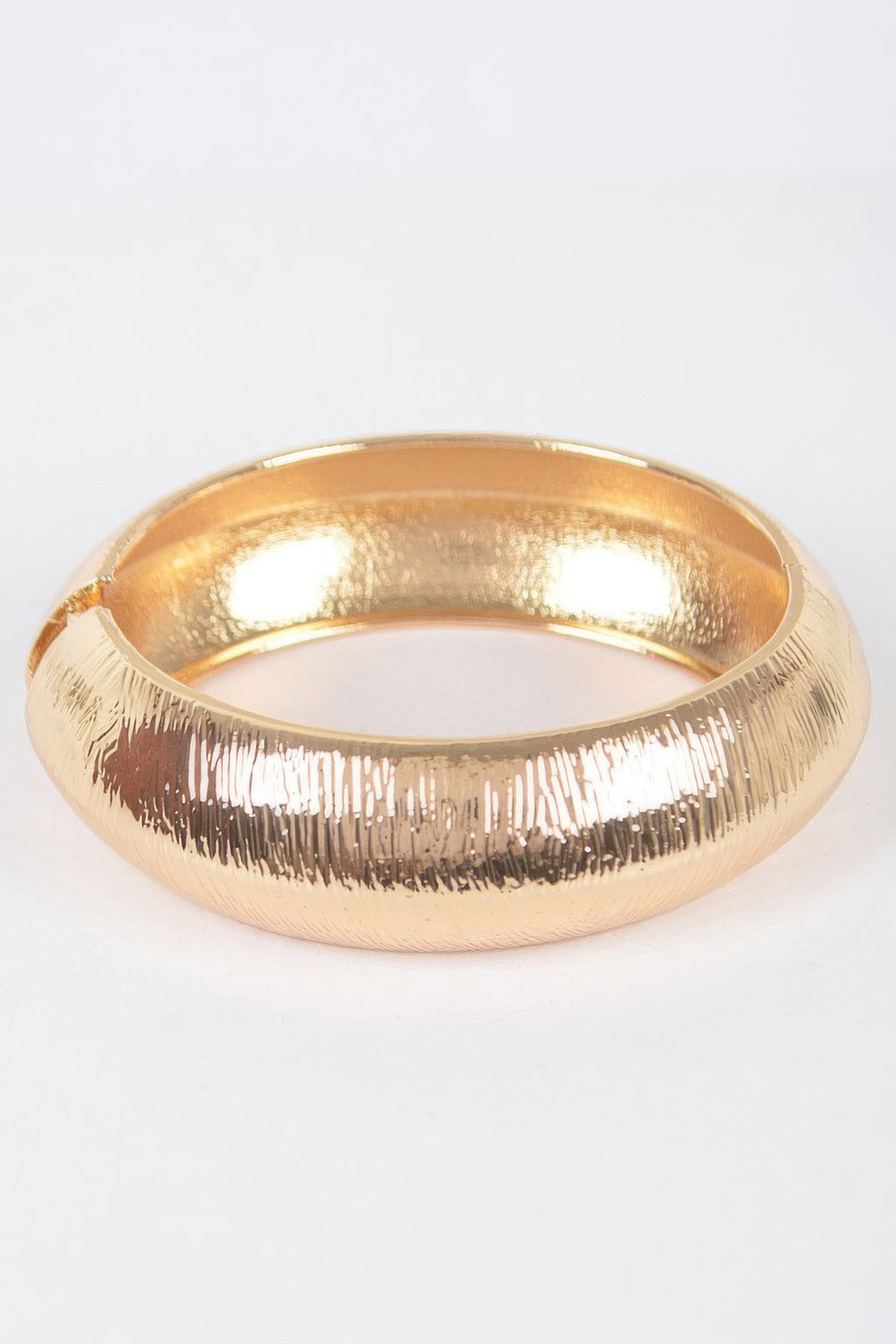 Textured metal bangle bracelet, gold finish with grooved edge detail