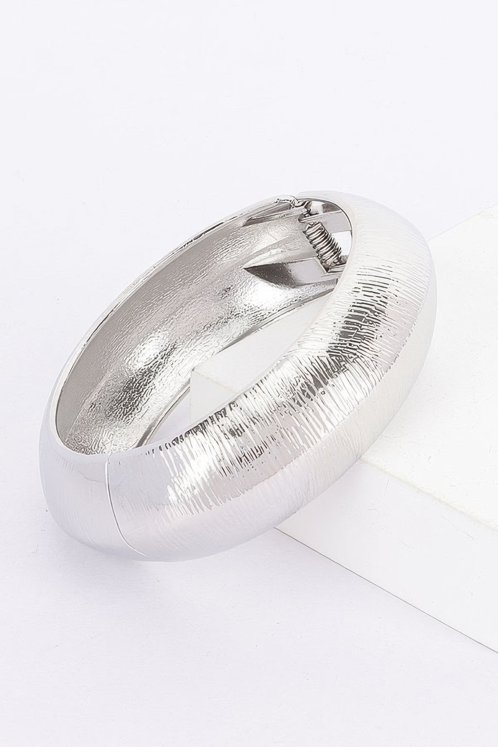 Textured metal bangle bracelet, silver finish; oval cuff with ribbed texture