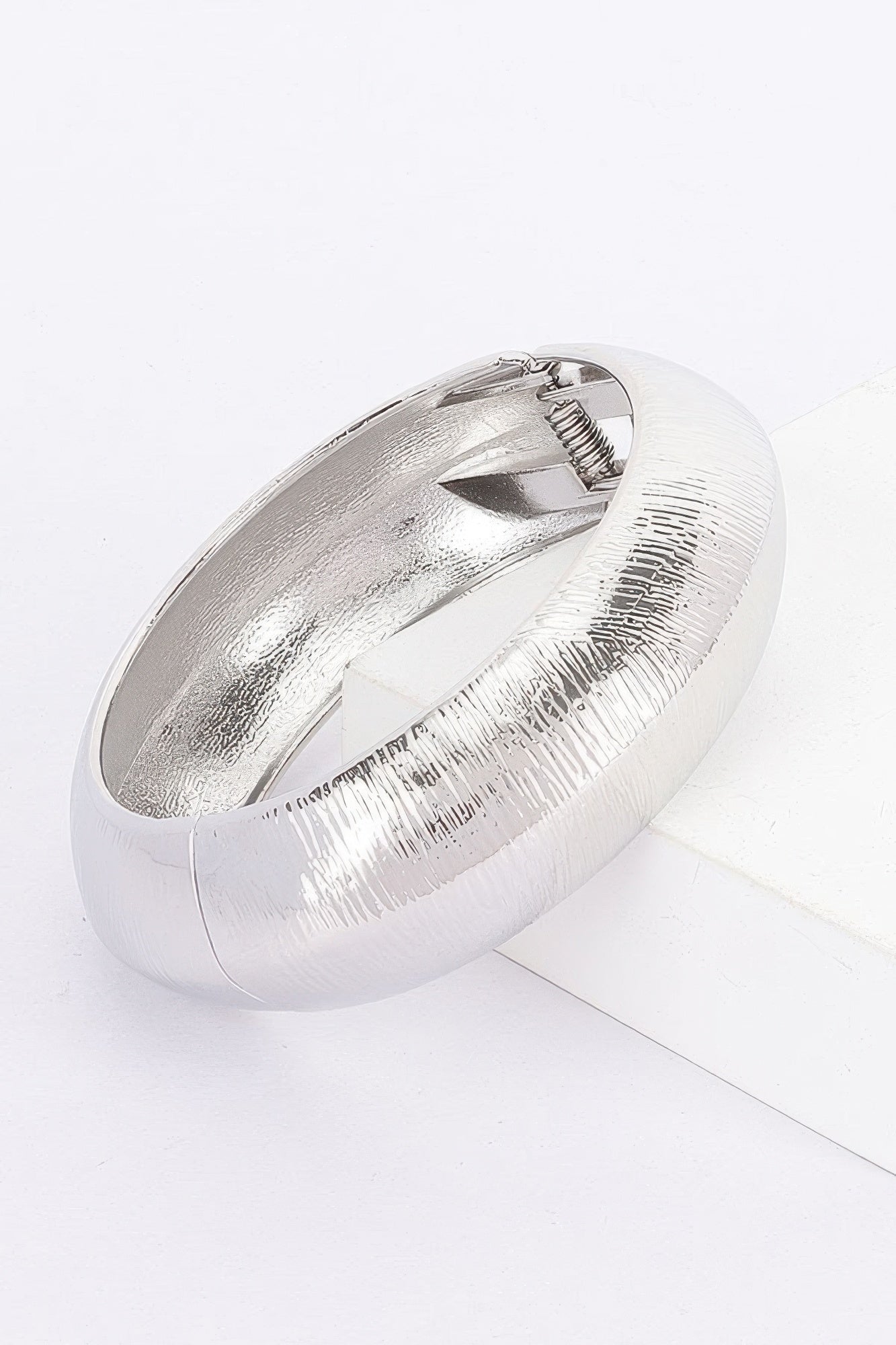 Textured metal bangle bracelet, silver finish; oval cuff with ribbed texture