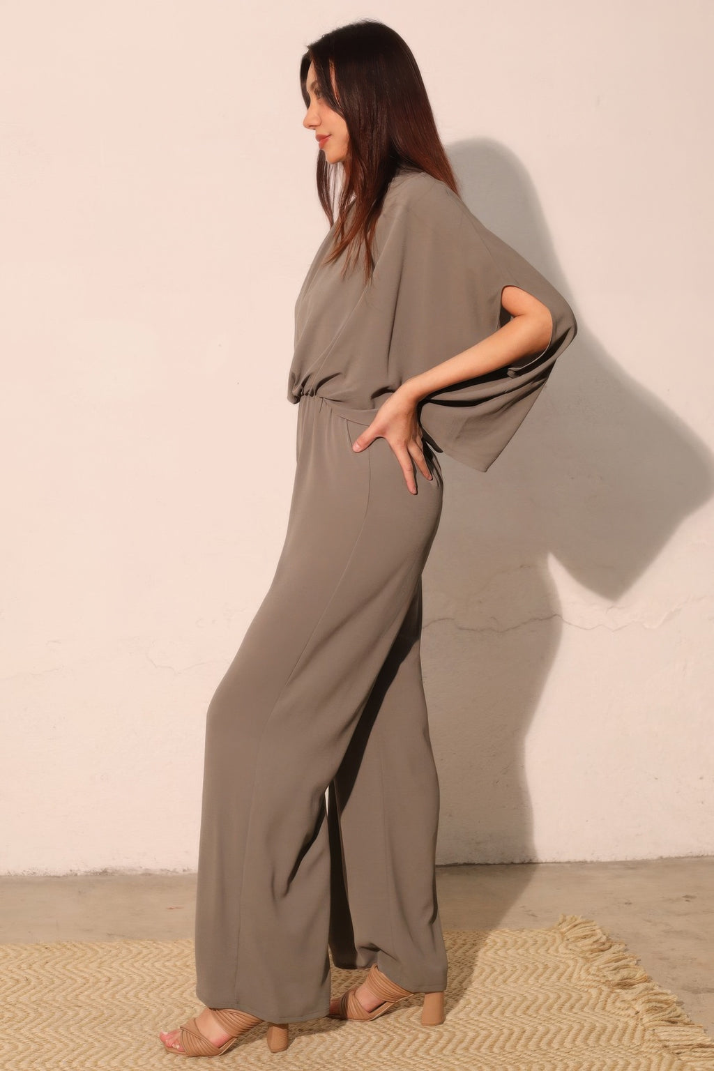Gray caftan jumpsuit side view with flowing wide-leg pants and elastic waist