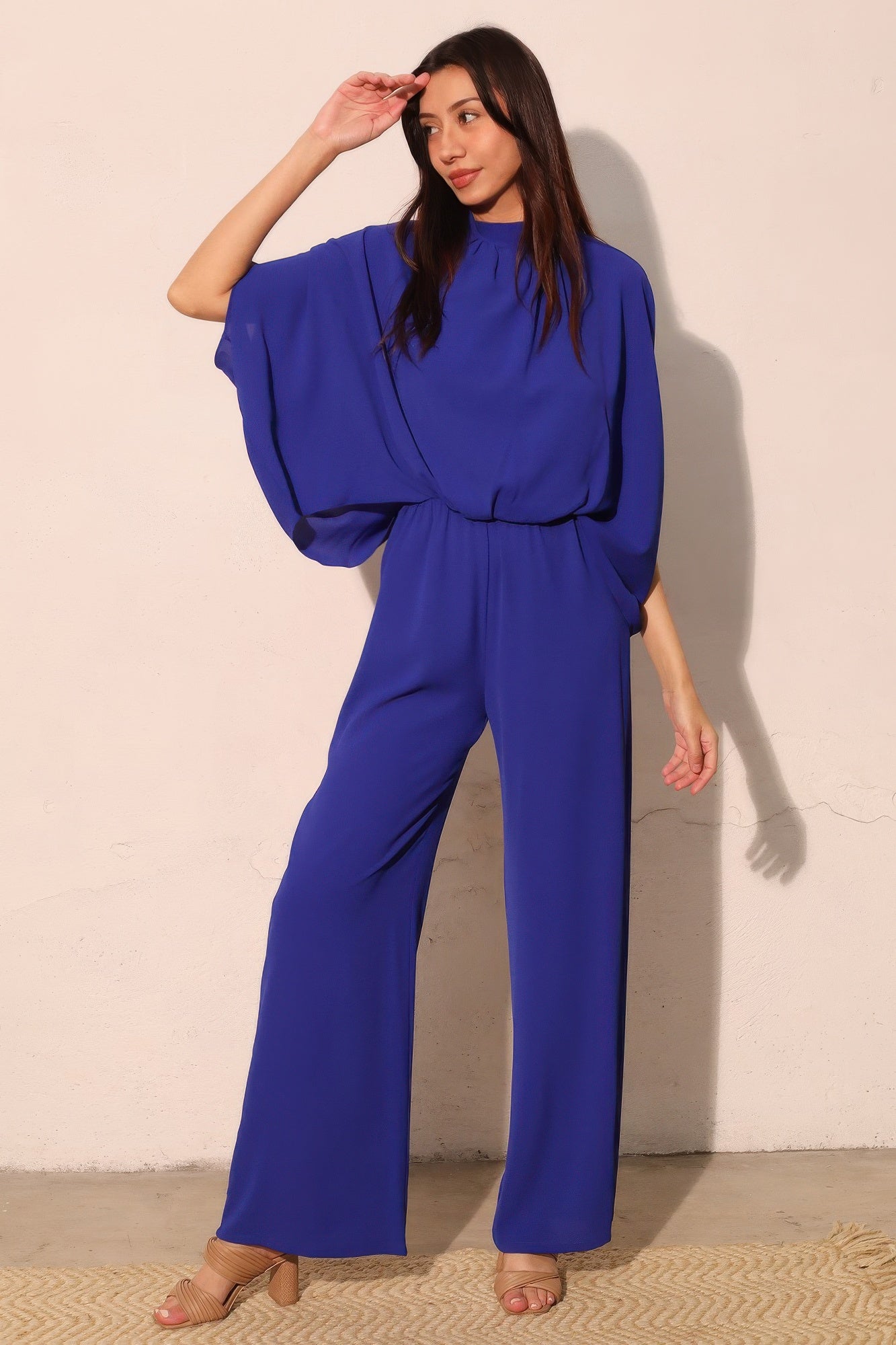 Royal blue mock neck caftan jumpsuit with dolman sleeves and wide-leg pants
