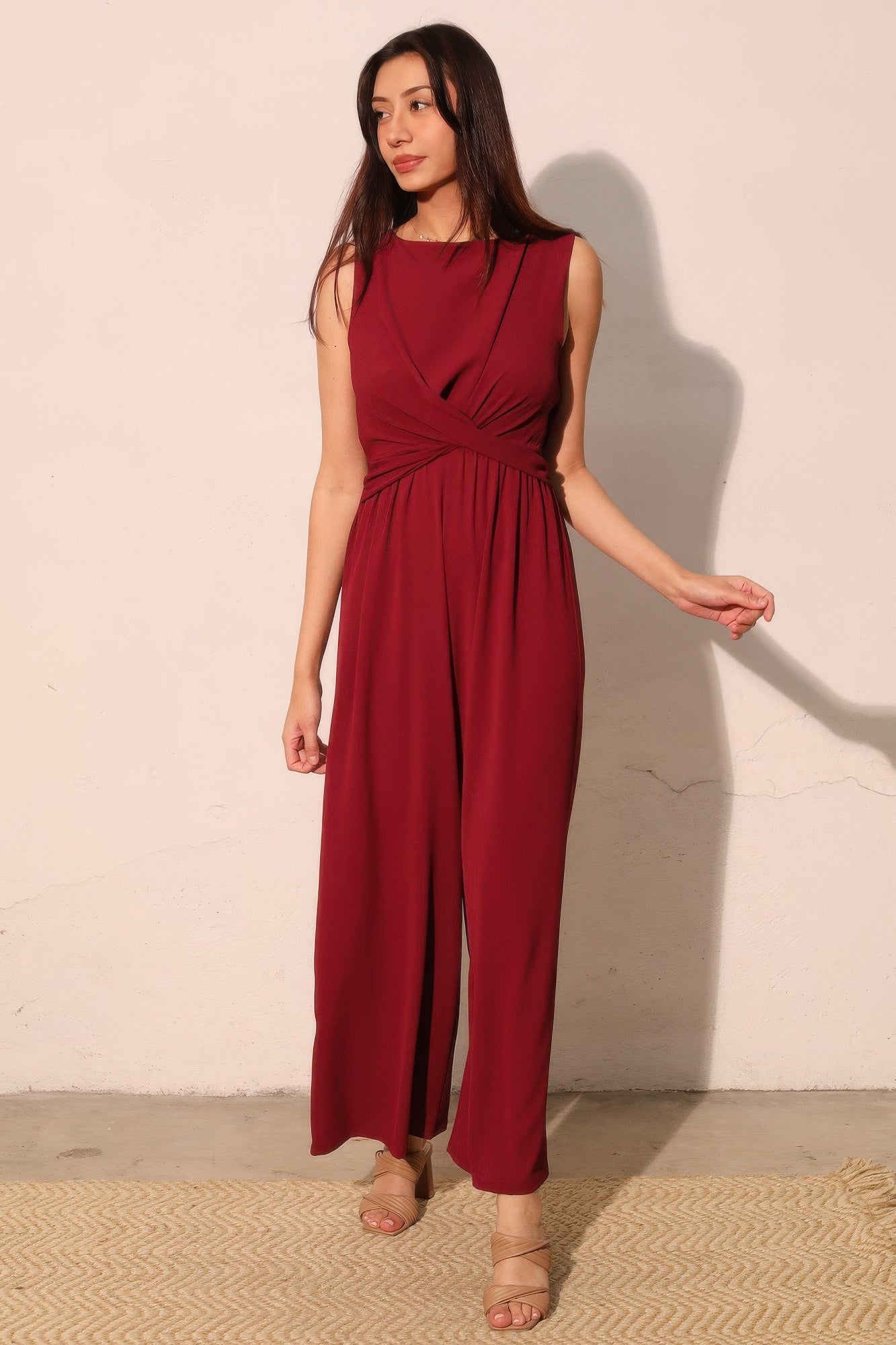 Wine-red jumpsuit with twist-front detail and flowing wide-leg pants