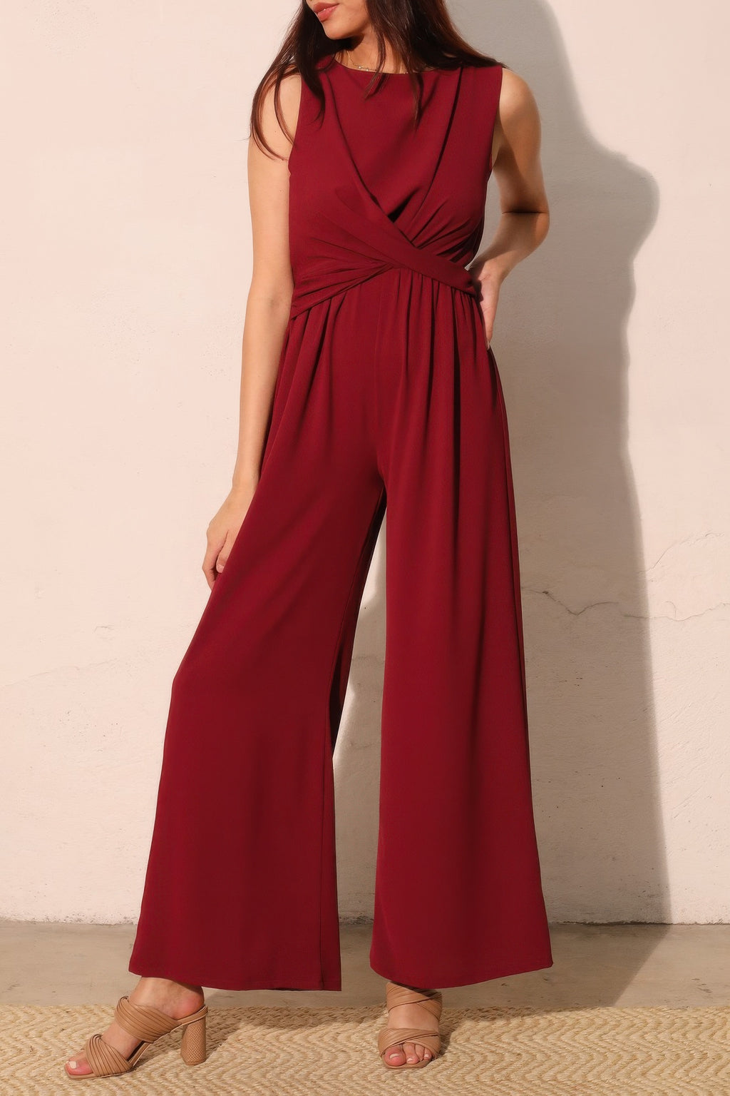 Wine-red sleeveless jumpsuit with twist waist and wide pant legs