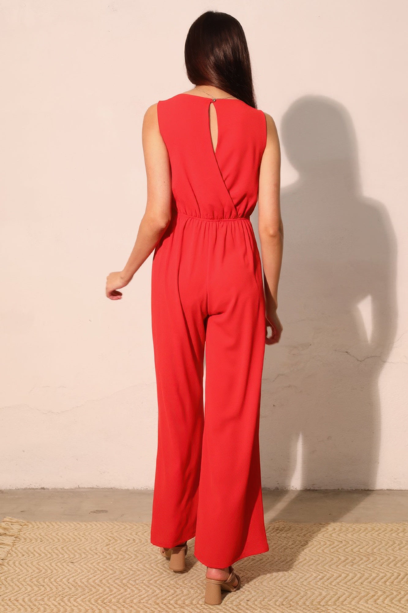 True red twist-front jumpsuit, open back keyhole and wide-leg fit