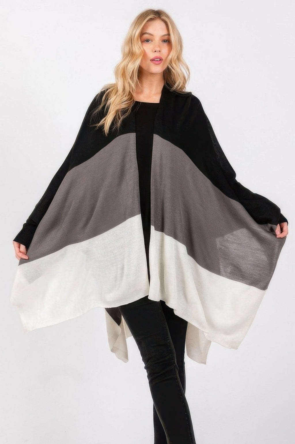 Three-tone ruana with black, gray, and white color-blocking; flowing open front.