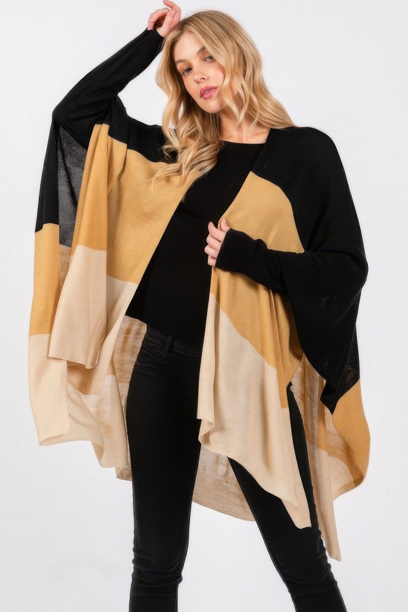Three-tone ruana in black with tan, cream, and beige stripes; drapes over shoulders.