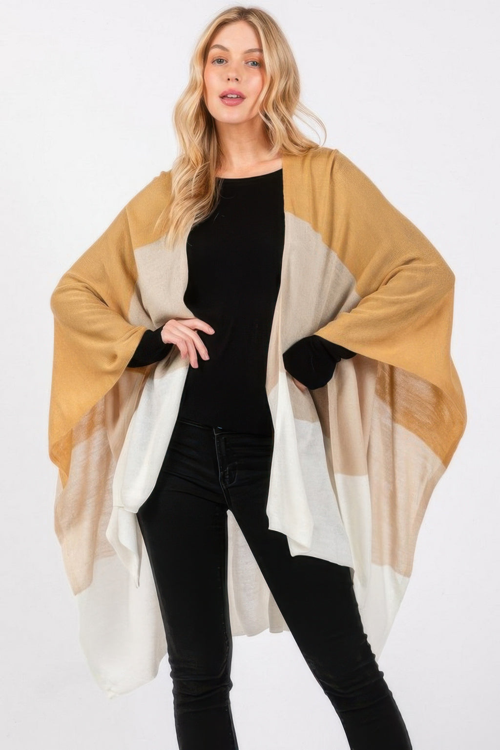 Three-tone ruana in warm beige, light beige, and darker panels; open poncho wrap.