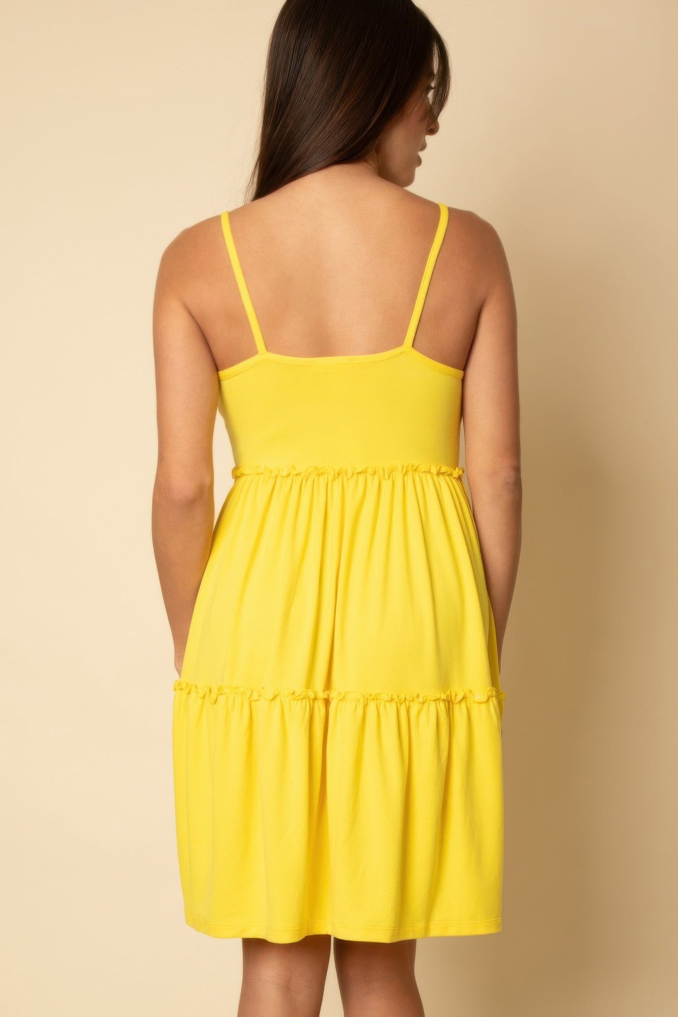 Back view of yellow tiered cami swing dress with spaghetti straps and tiered ruffles