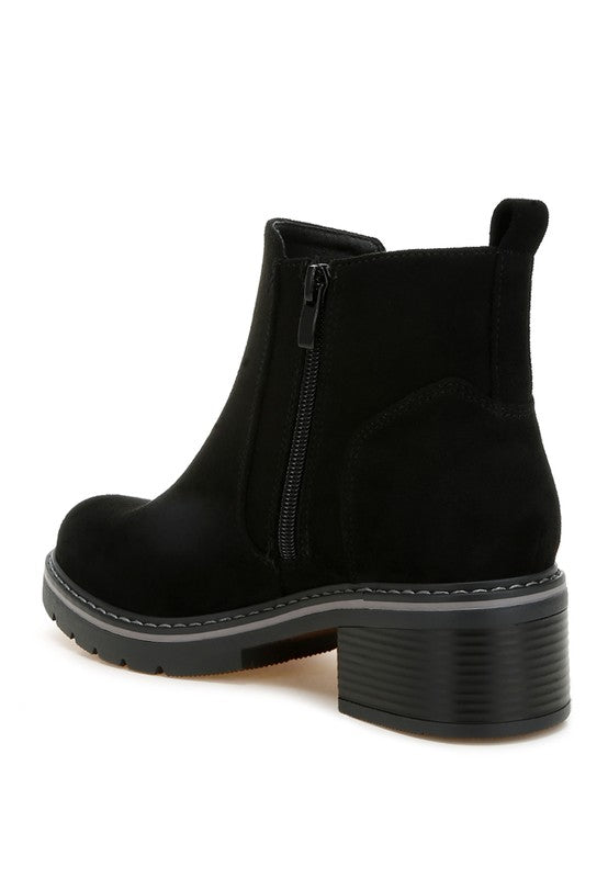 Black microfiber zipper boot, side view, low block heel and ridged sole