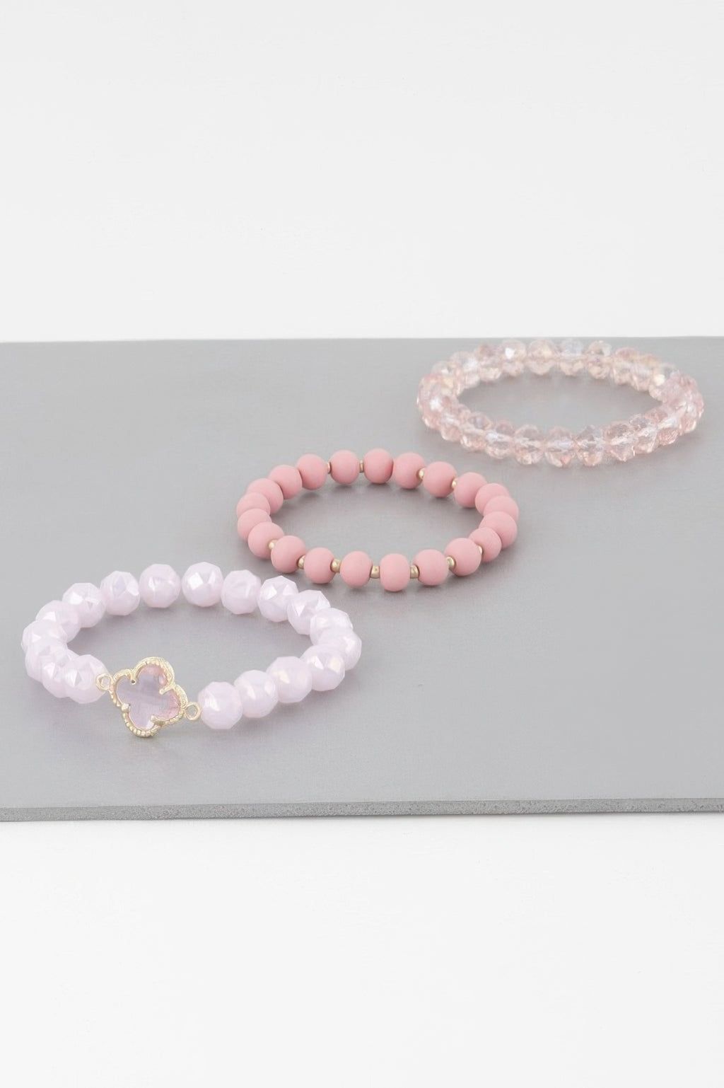 Clover crystal bead bracelet set in white, pink, and pale pink with gold charm